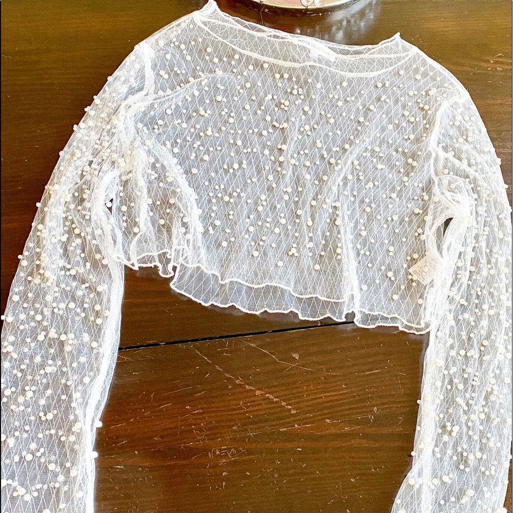 Sheer crop top embellished with pearls.